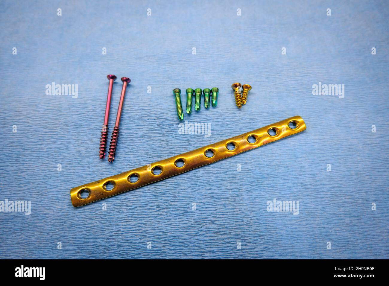 an explanted titanium surgical tube plate and titanium screws