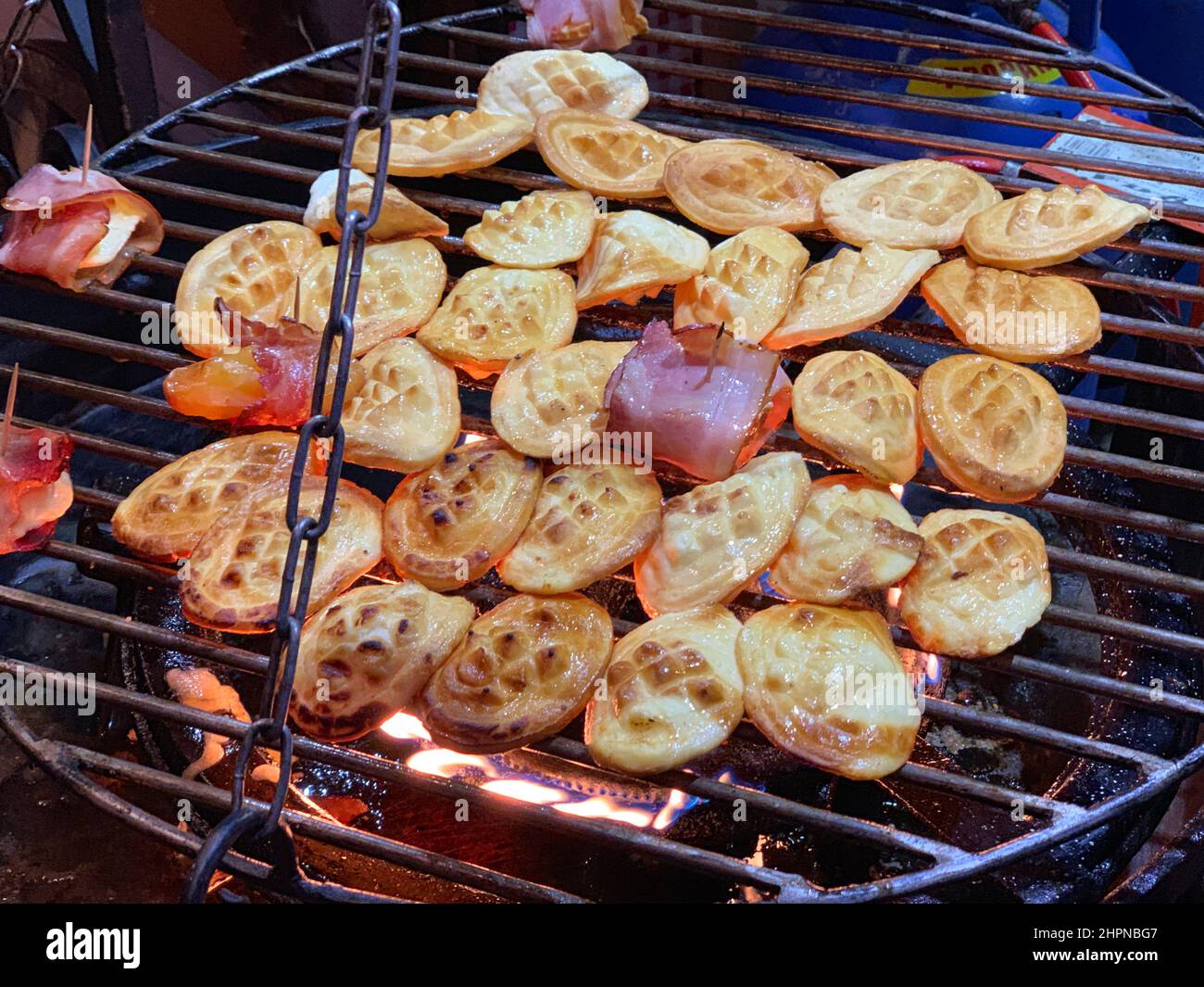 Traditional Polish smoked goat cheese roasted over the fire with bacon in Gdansk in Poland during Christmas Stock Photo