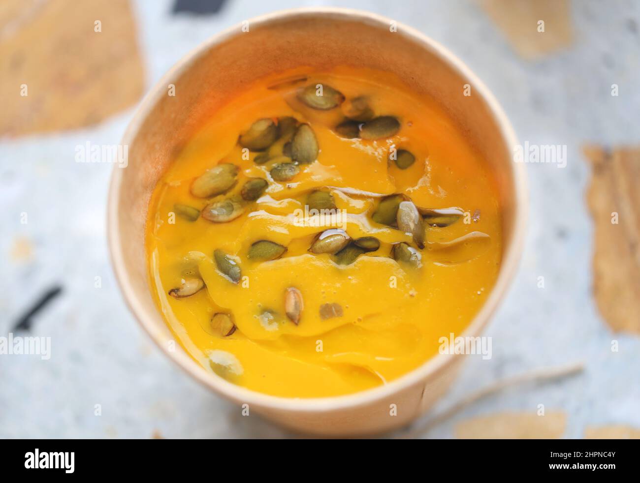 Beautiful delicious pumpkin soup with seeds in a plate photographed close-up Stock Photo