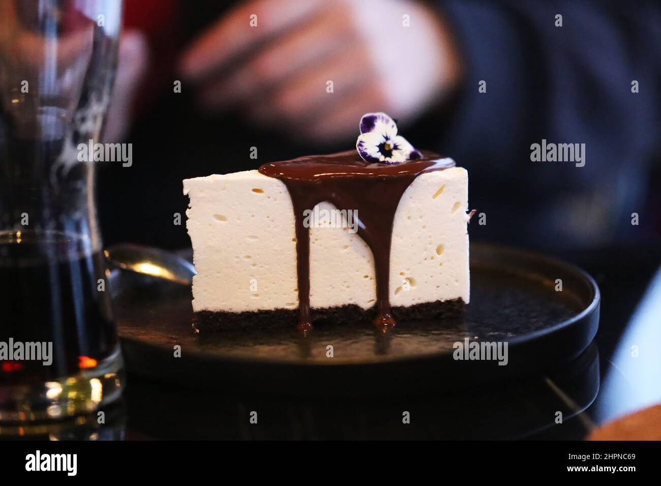 Beautiful delicious cheesecake with chocolate on a plate take a close-up photo Stock Photo