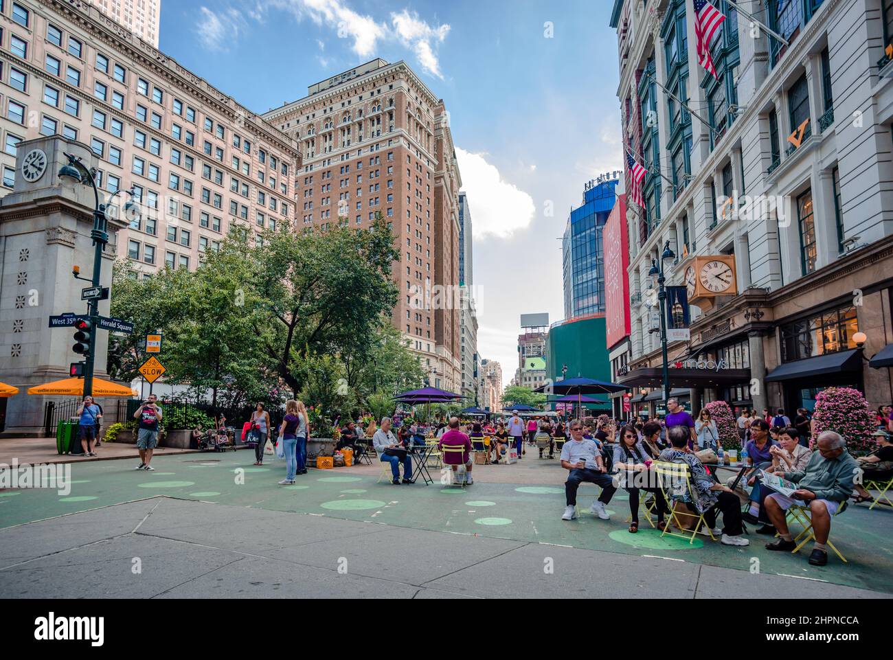 Herald Square in midtown Manhattan, NY, with incidental people enjoying sitting in sidewalk cafes. Stock Photo