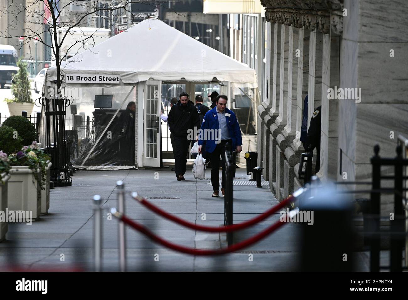 New York, USA. 22nd Feb, 2022. Traders are seen passing through a security tent as they return to the New York Stock Exchange as the DOW reacts to the news that Russian President Vladimir Putin ordered troops into Ukraine, New York, NY, February 22, 2022. Stocks tumbled as crude oil price surged while the United States and its allies announced economic sanctions against Russia for its incursion into Ukraine. (Photo by Anthony Behar/Sipa USA) Credit: Sipa USA/Alamy Live News Stock Photo