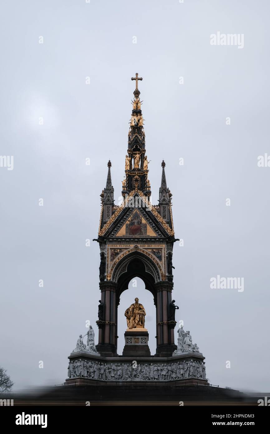 Center Front Elevation Shot of Neo-Gothic Memorial to Prince Albert with motion blurred people in Hyde Park, Kensington, London, UK in winter 2022 Stock Photo