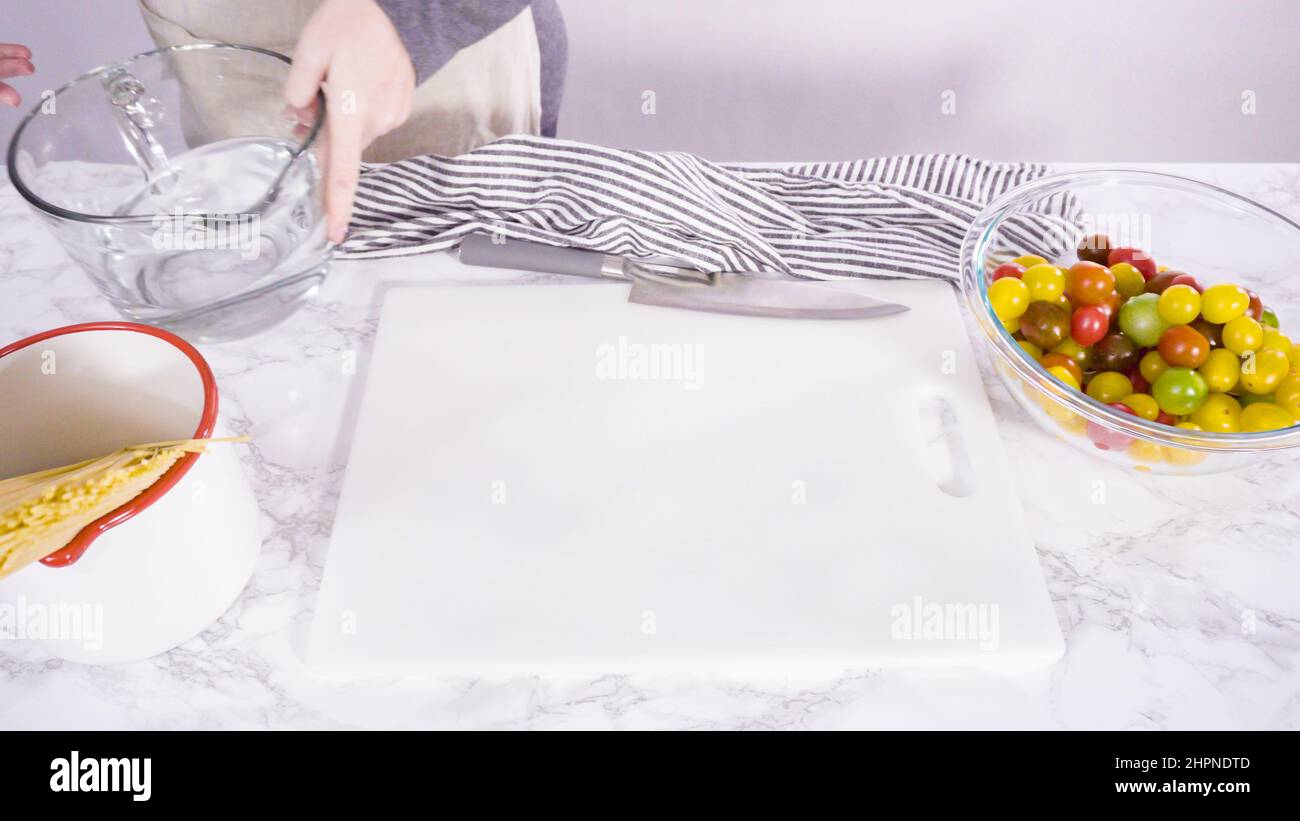 Step by step. Cutting vegetables on a white cutting board to make a one