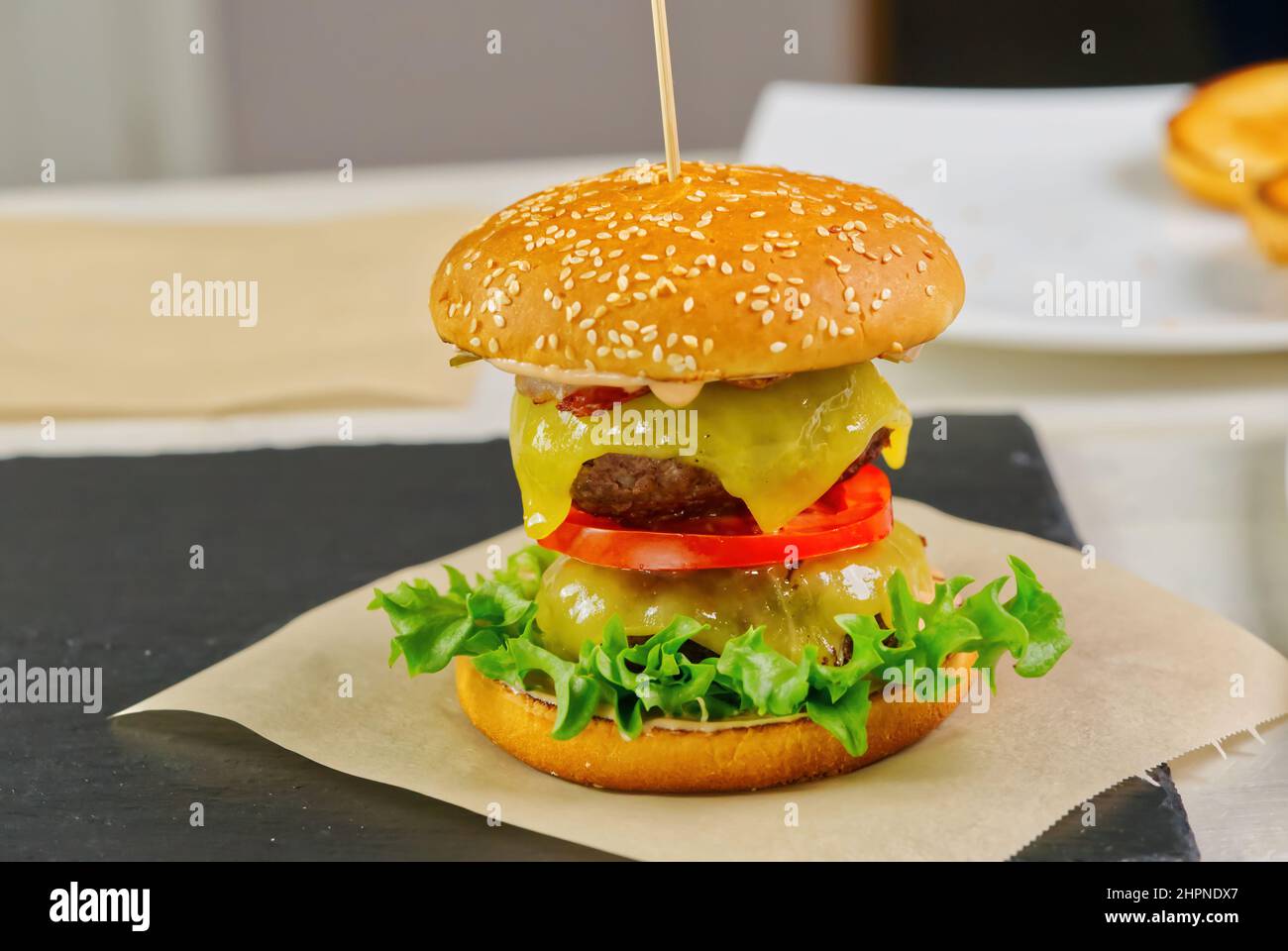 Big double burger on black stone plate. homemade cheeseburger Stock Photo