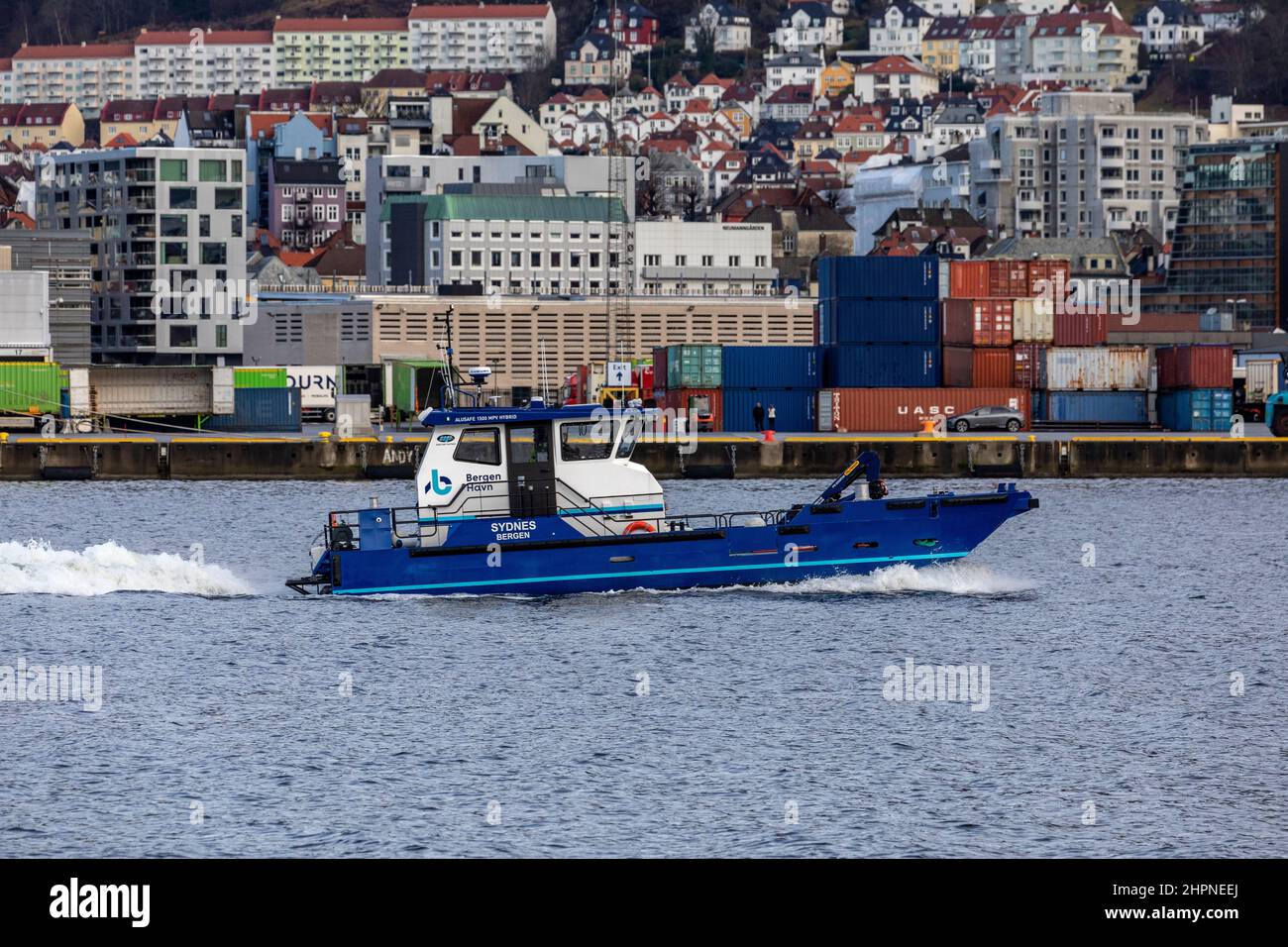 MB 'Sydnes', Bergen port authority's maintenance and service boat,  in port of Bergen, Norway. Jekteviken terminal in background Stock Photo