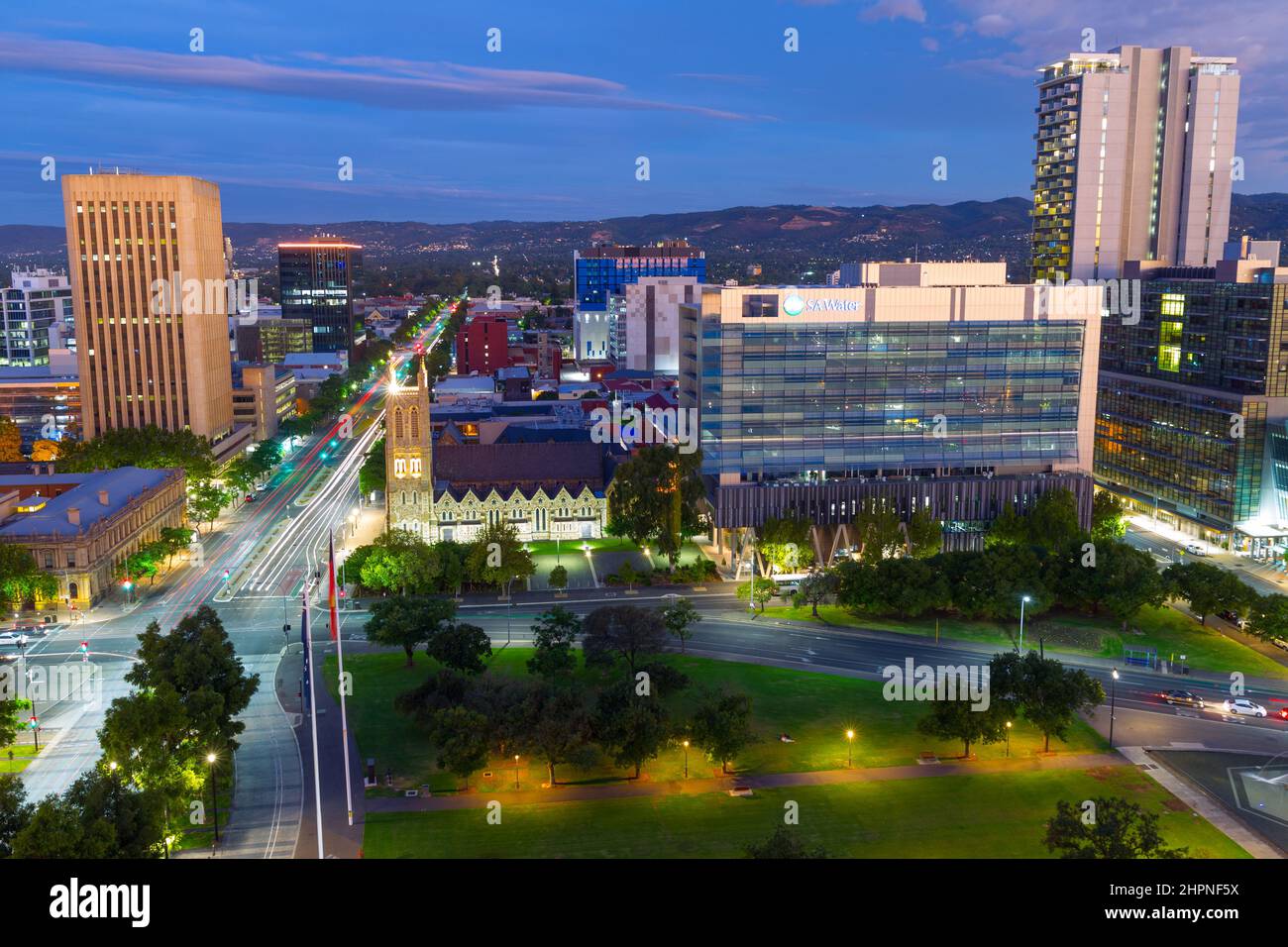 Adelaide, South Australia, seen by night from Victoria Square looking east along Wakefield Street, with the Mount Lofty Ranges in the background. Stock Photo