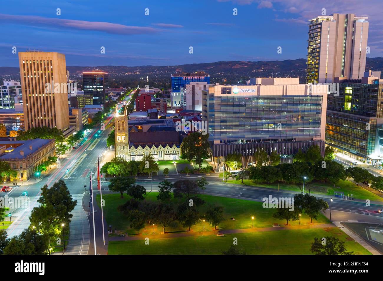 Adelaide, South Australia, seen by night from Victoria Square looking east along Wakefield Street, with the Mount Lofty Ranges in the background. Stock Photo