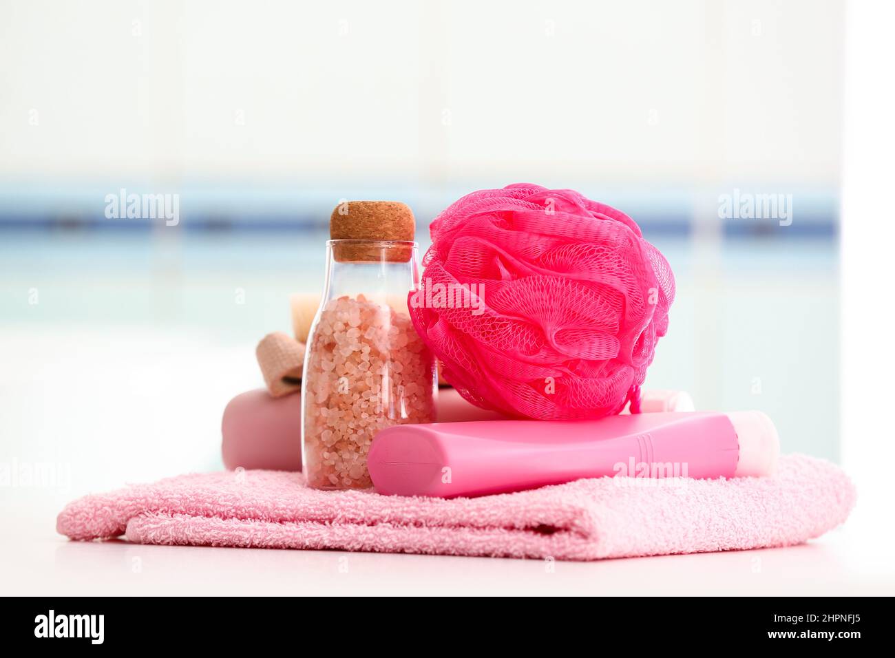Clean towel, cosmetic products and bath sponge on table Stock Photo Alamy