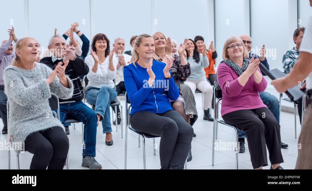 Retiree Smiling Smiling happy retirees studying in bussiness centre Stock Photo - Alamy