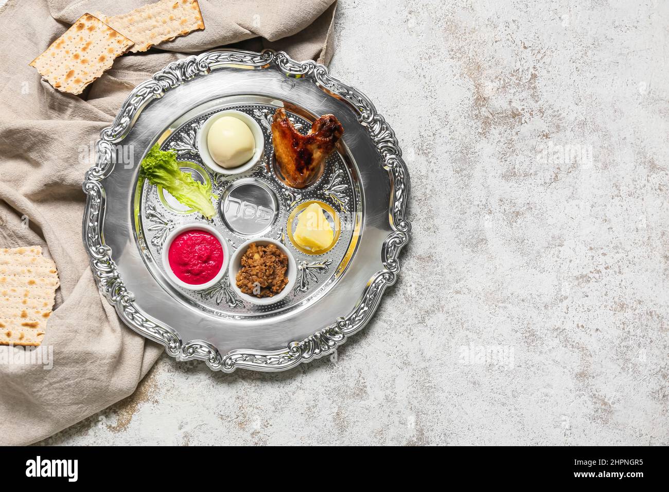 Passover Seder plate with traditional food and matza on light ...