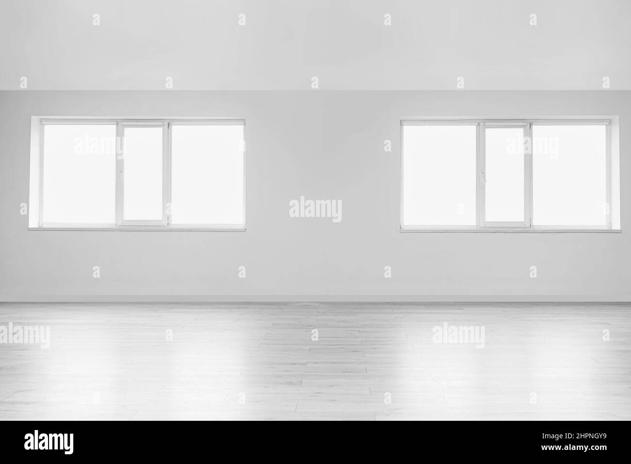 View of light wall with windows in big empty room Stock Photo