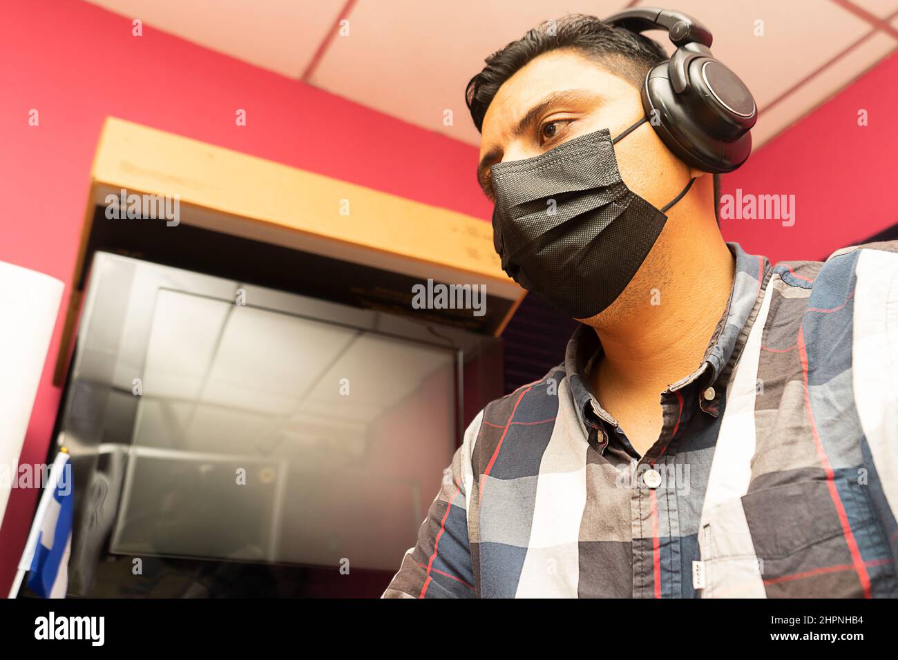 Latino man working with his covid 19 mask on correctly Stock Photo