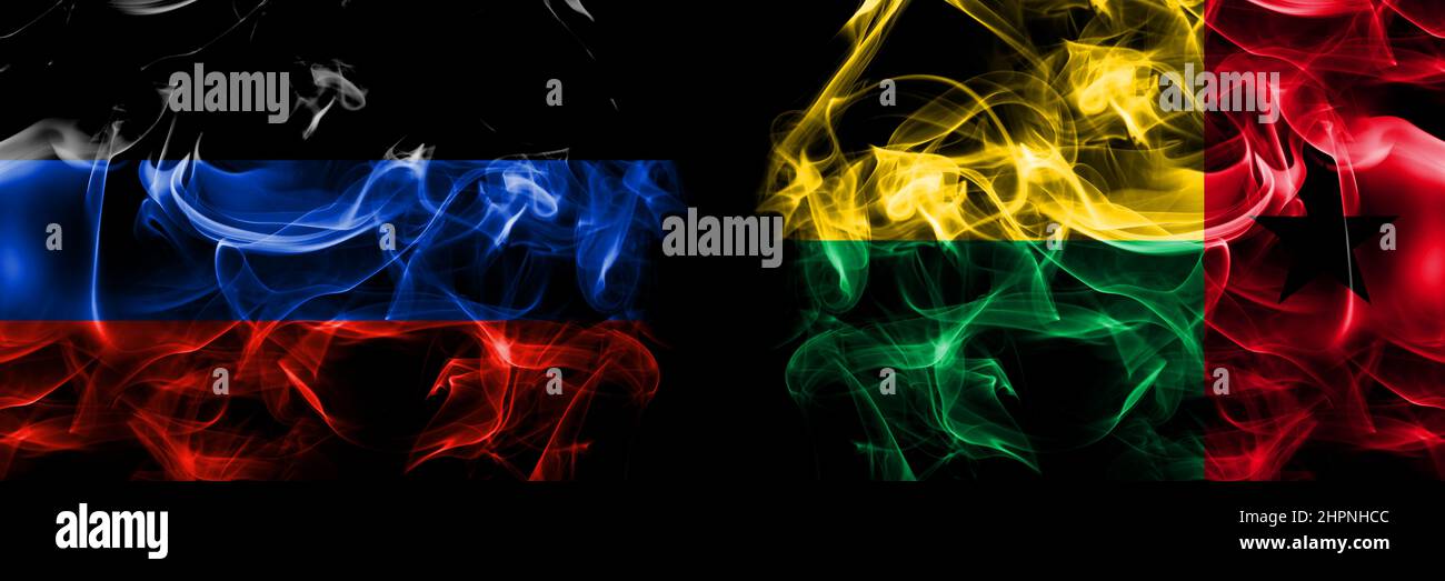 Donetsk People's Republic vs Guinea Bissau flag. Smoke flags placed side by side isolated on black background. Stock Photo