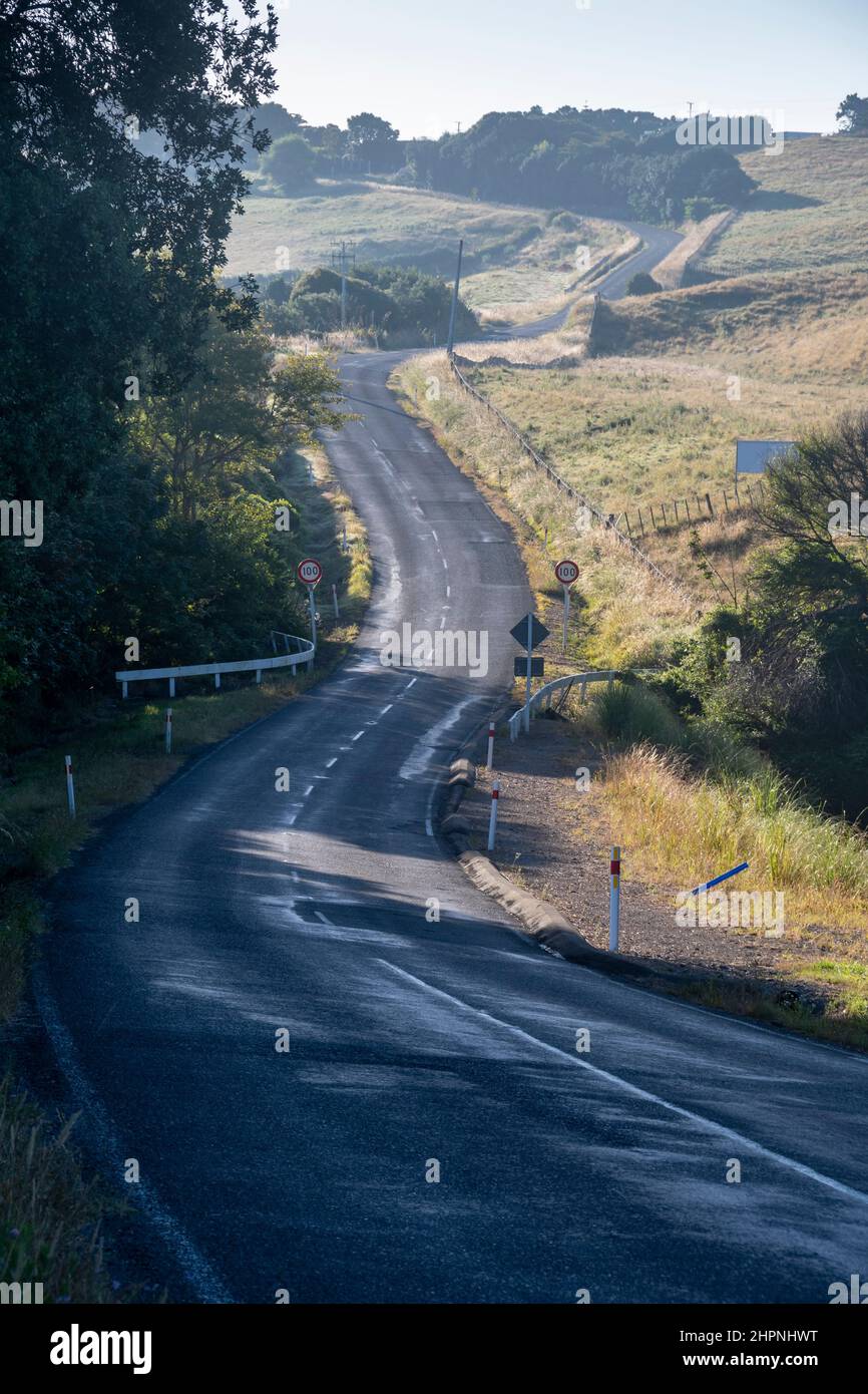 Country road winding through farmland near Kai Iwi Beach, near Wanganui, North Island, New Zealand Stock Photo