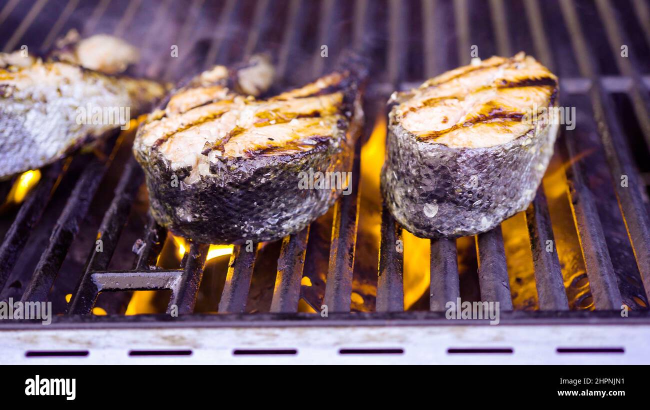 Grilling salmon steaks on an outdoor gas grill Stock Photo Alamy