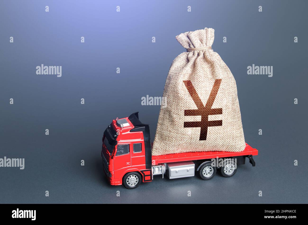 Truck with a chinese yuan or japanese yen money bag. Loan or deposit. High super income. Payment of taxes. Debt load. Money transfers and transactions Stock Photo