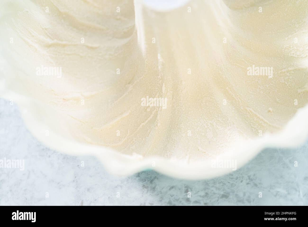 Close up view. Greasing bundt cake pan with vegetable shortening and