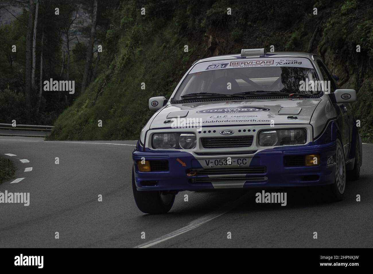 Sports white car running fast in the turn asphalt rally in Barcelona ...