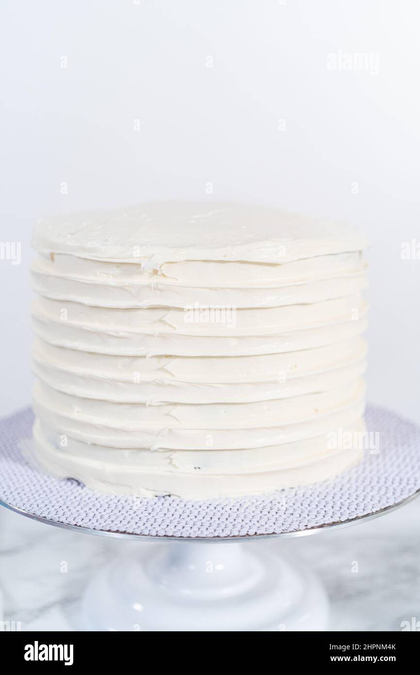 Frosting chocolate cake with vanilla buttercream frosting Stock Photo