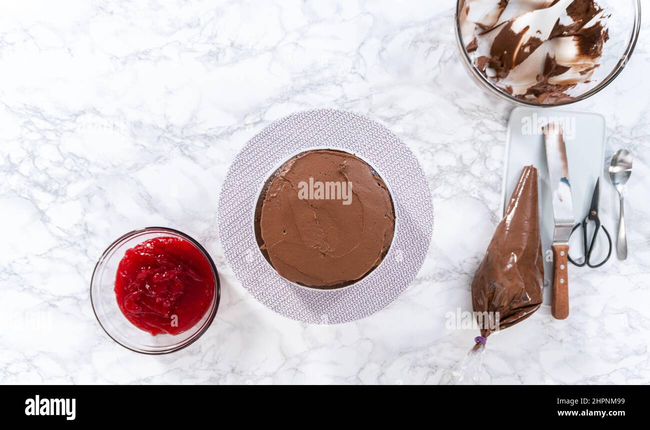 Flat lay. Covering chocolate cake with a crumb layer of chocolate