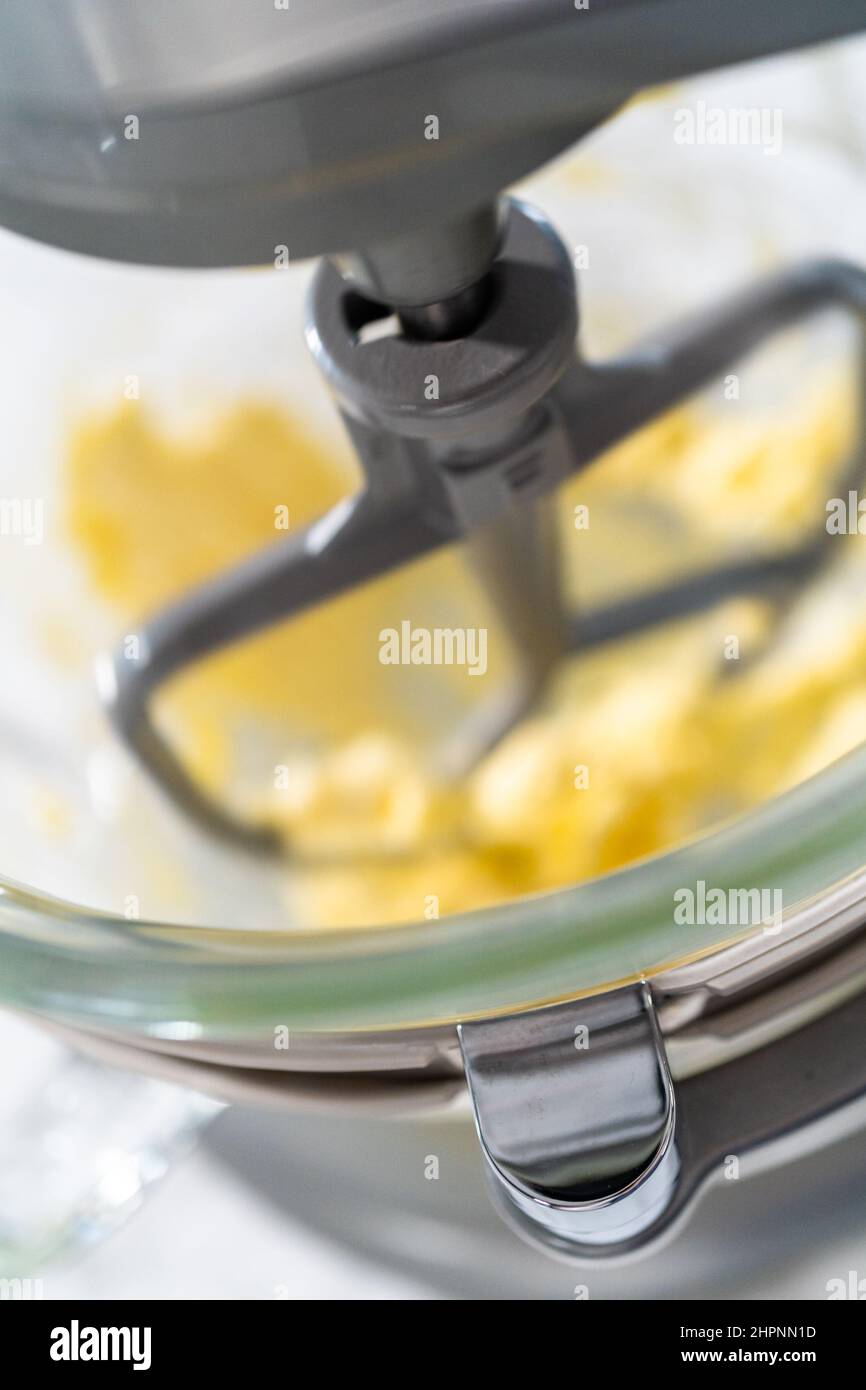 Mixing ingredients in a kitchen stand mixer to bake soft oatmeal raisin