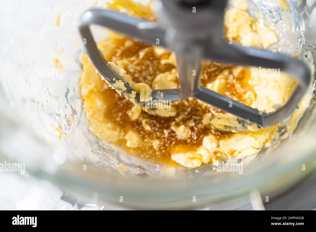 Mixing ingredients in a kitchen stand mixer to bake soft oatmeal raisin