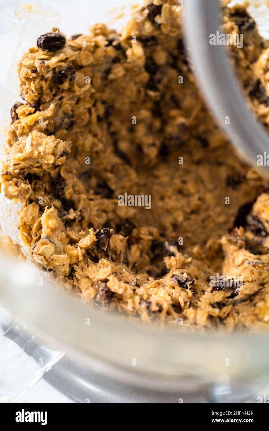 Mixing ingredients in a kitchen stand mixer to bake soft oatmeal raisin