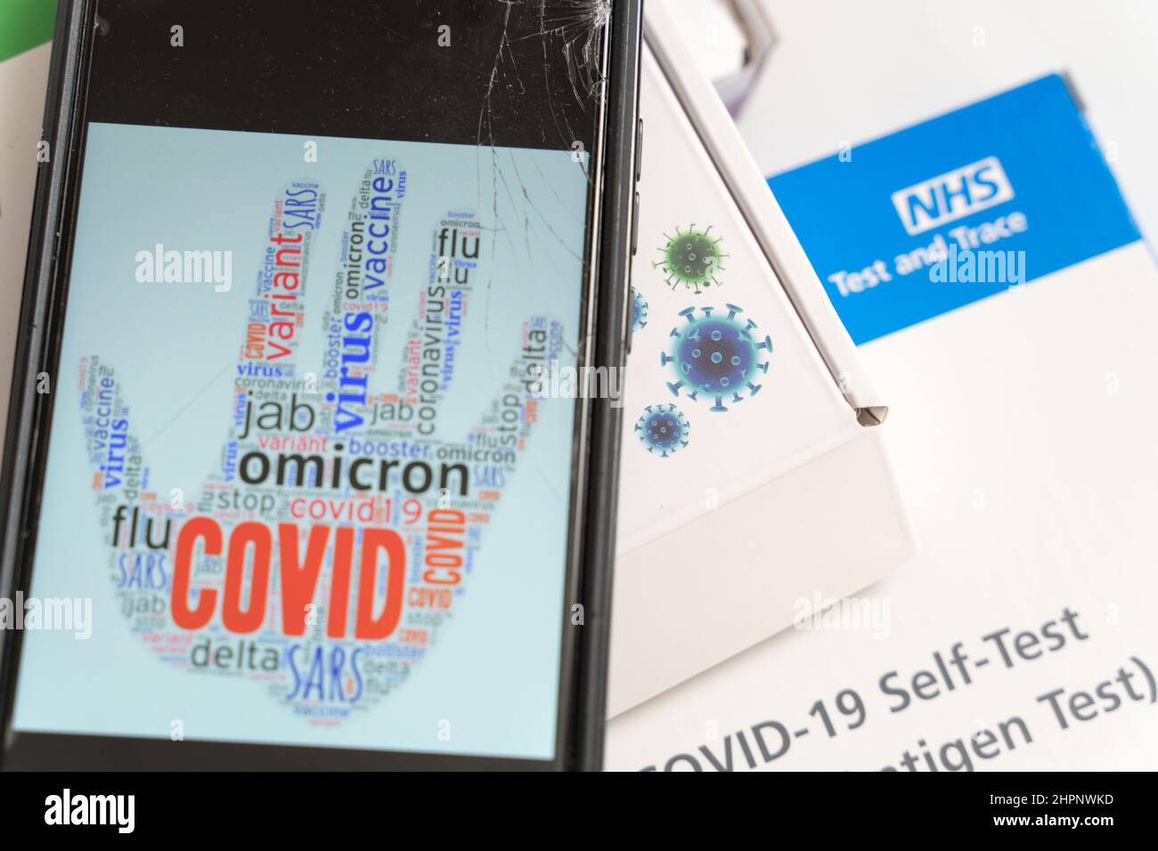 Mobile device showing COVID sign while England are finding a way out of pandemic , learn to live with COVID Stock Photo
