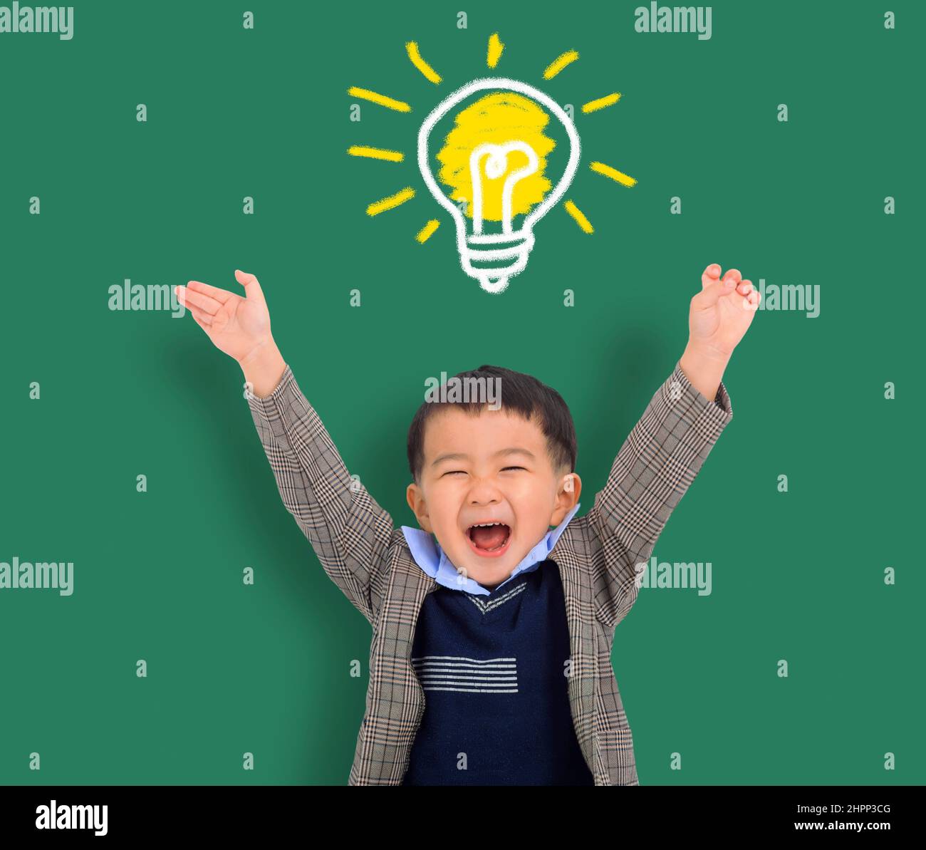 Happy Child student thinking and light bulb on the chalkboard . Cute little boy has an new idea. Innovation technology and education concept Stock Photo