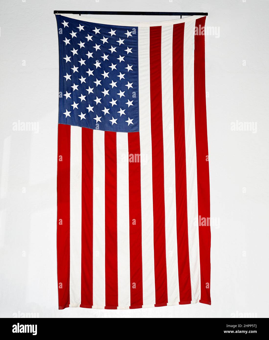 Large American Flag hanging on Wall Stock Photo