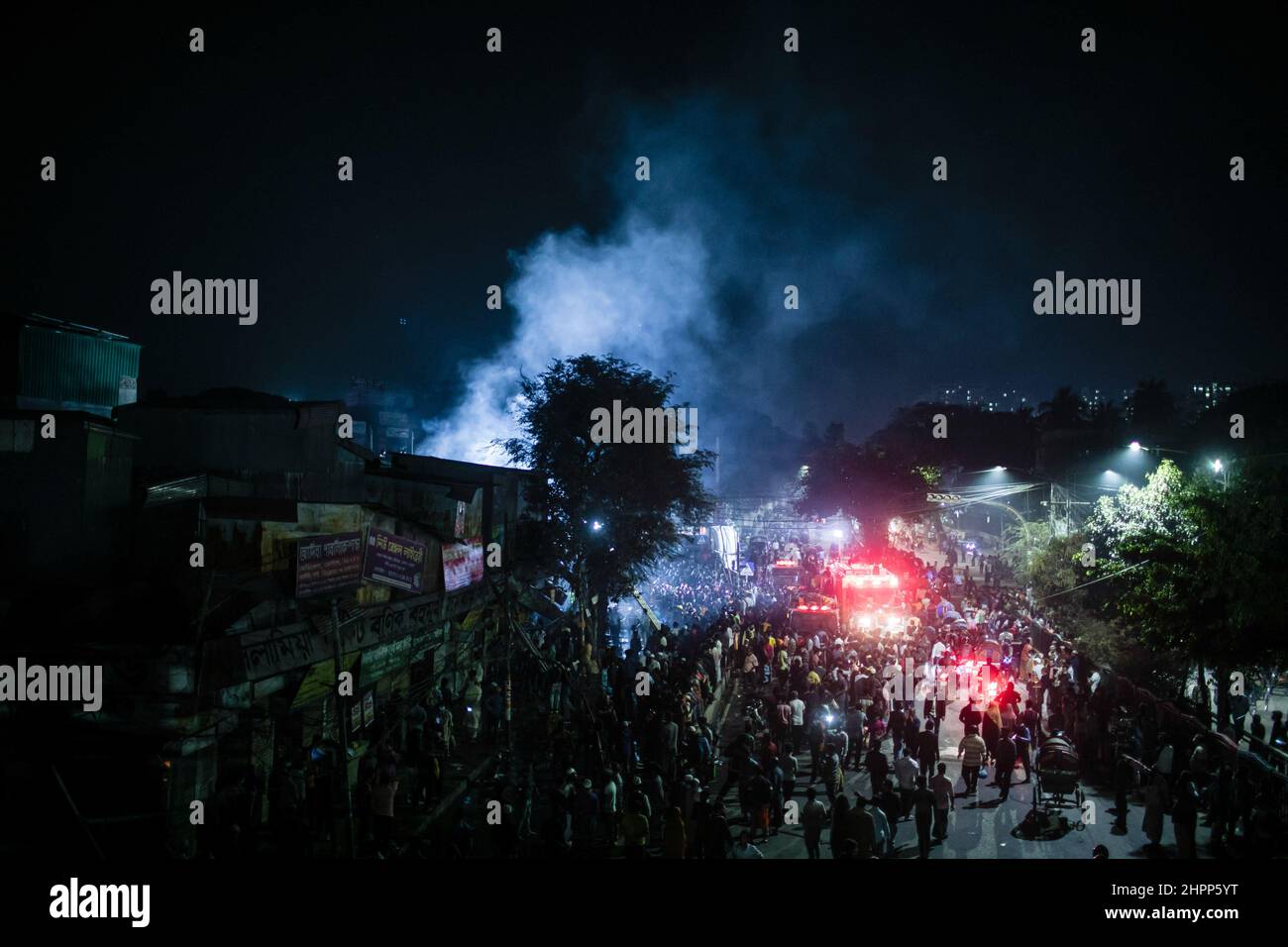 Dhaka, Bangladesh. 22nd Feb, 2022. View of people around the scene of devastating fire that broke out at Book shops at the market in Nilkhet area of the capital on Tuesday afternoon. The fire originated from the book shops of Bakusha Hawkers Market around 7:47 pm. Abdul Halim, assistant director of Fire Service and Civil Defence Headquarters, confirmed that the fire that erupted, has been brought under control around 8:45 pm after two-hour long efforts of 10 firefighting units. (Photo by Sazzad Hossain/SOPA Images/Sipa USA) Credit: Sipa USA/Alamy Live News Stock Photo