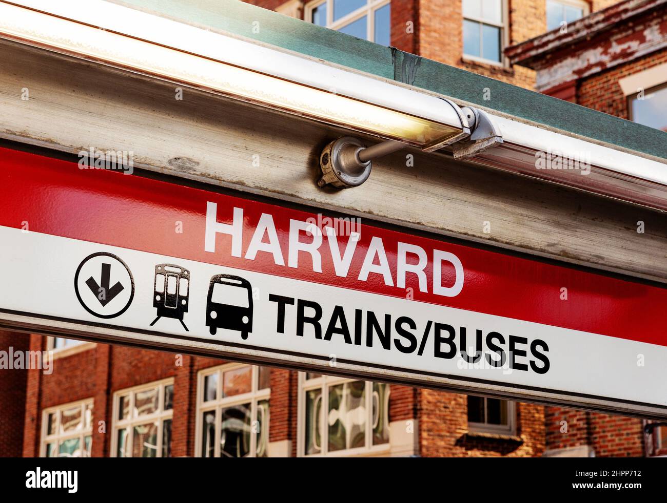 Cambridge, Massachusetts, USA - February 16, 2022: Close-up of sign for Harvard Square MBTA Red Line subway and bus station. Harvard Square buildings Stock Photo