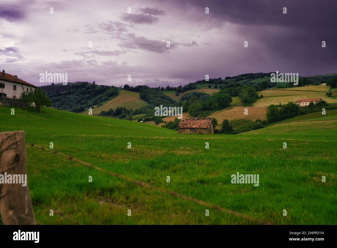 Beautiful view of a green field and rural houses on a cloudy day in the ...