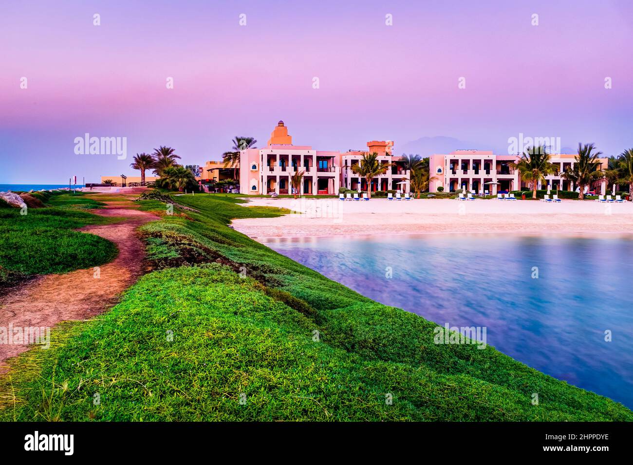 Ras Al Khaimah, UAE - November 18 2014: Hilton Ras Al Khaimah Beach Resort surrounded by desert, mountain, and sea. Stock Photo