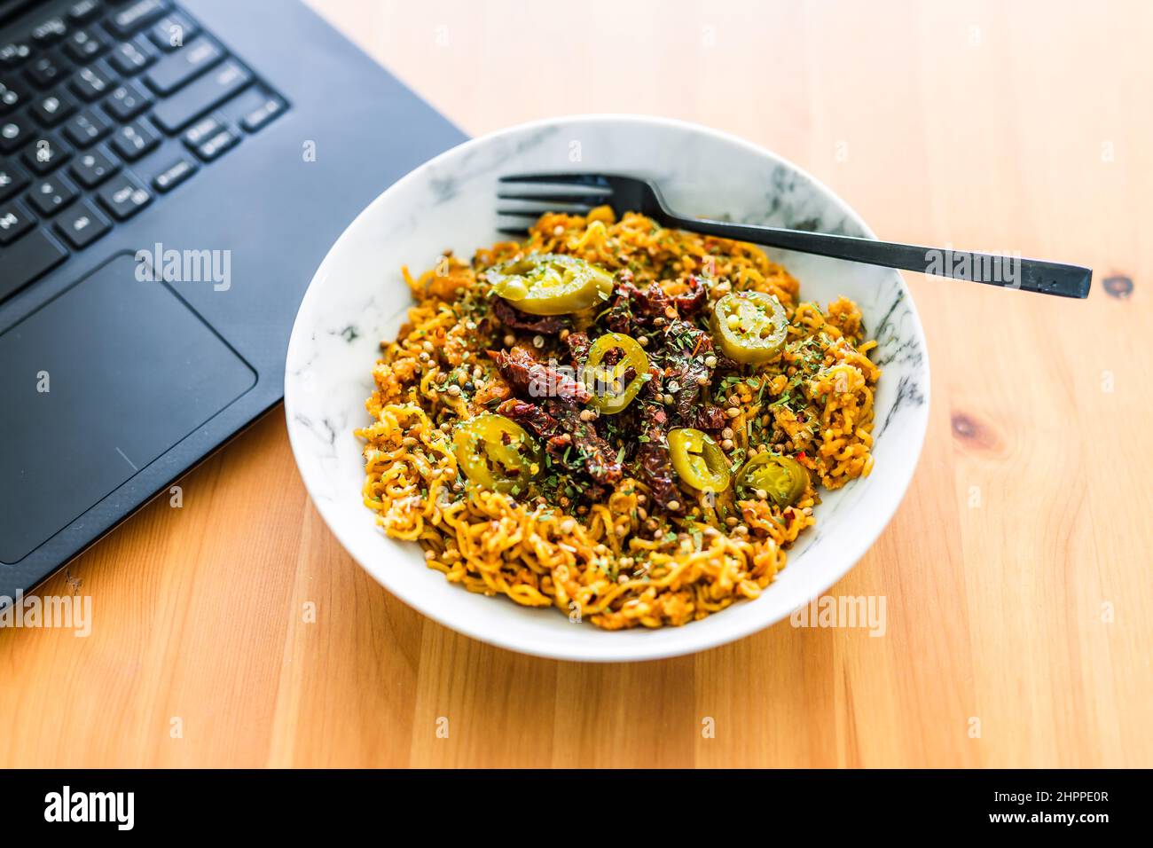 eating instant noodles with sundried tomatoes and jalapenos while