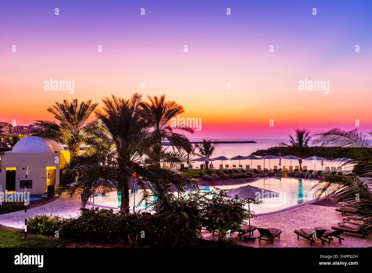 Ras Al Khaimah, UAE - November 18 2014: Hilton Ras Al Khaimah Beach Resort surrounded by desert, mountain, and sea. Stock Photo