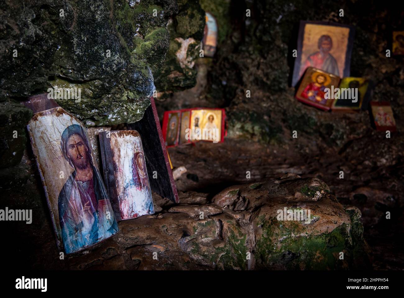 Interior of an old church cave with Christian saint pictures. Ayioi Saranta orthodox chapel Stock Photo