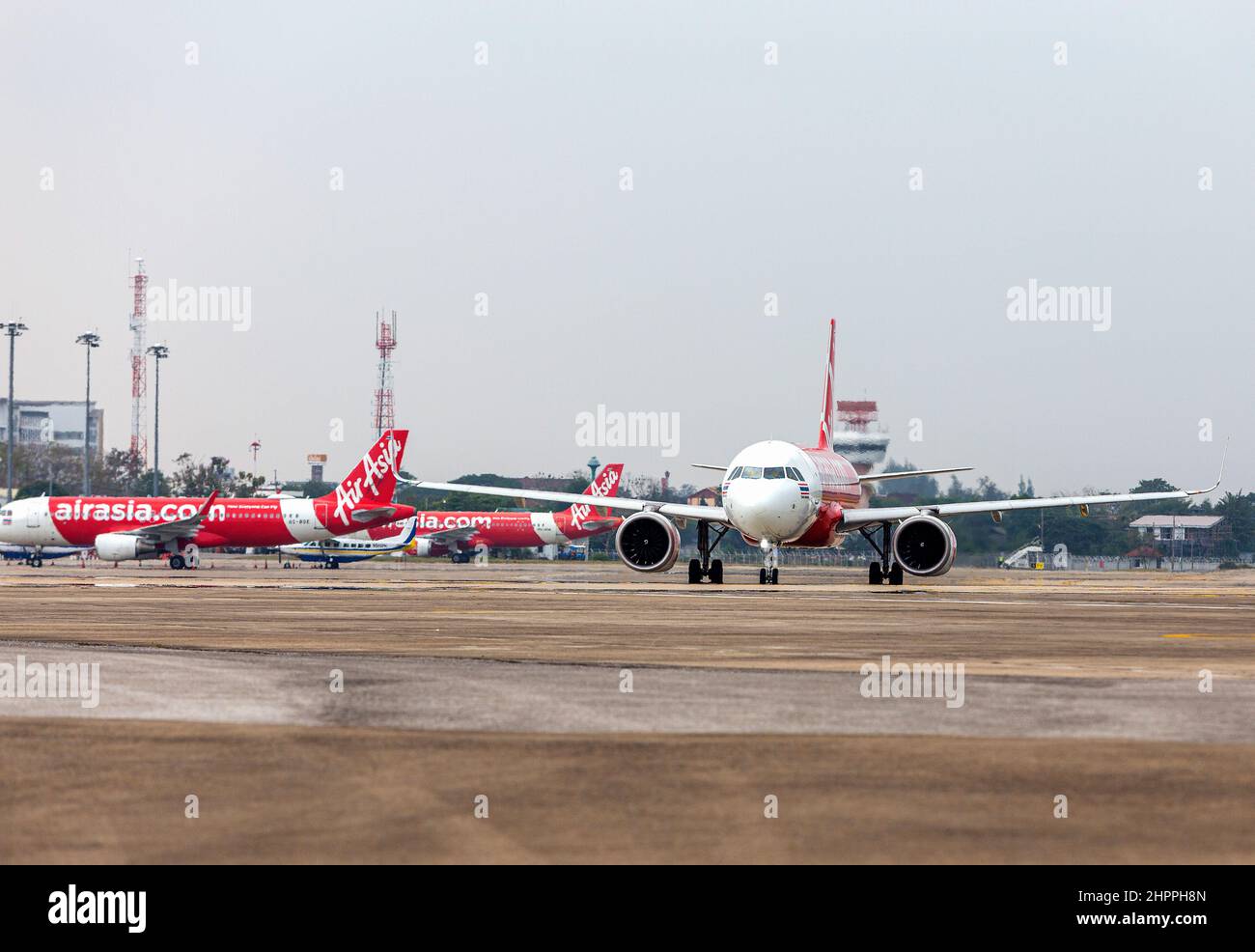 Chiang Mai, Thailand. 22nd Feb, 2022. Thai AirAsia airplane (R) runs on the runway at Chiang Mai International Airport (CNX). Thailand has raised the COVID-19 alert to level 4 following a sharp increase in omicron variant infections nationwide. Credit: SOPA Images Limited/Alamy Live News Stock Photo
