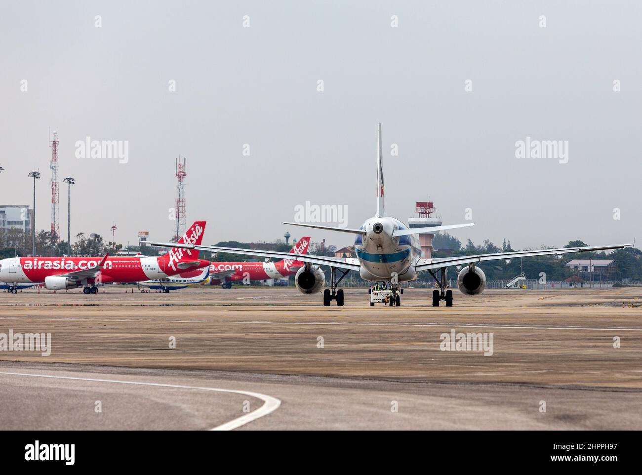 Chiang Mai, Thailand. 22nd Feb, 2022. Bangkok Airways airplane (R) and Thai AirAsia airplane (L) seen on the apron at Chiang Mai International Airport (CNX). Thailand has raised the COVID-19 alert to level 4 following a sharp increase in omicron variant infections nationwide. Credit: SOPA Images Limited/Alamy Live News Stock Photo