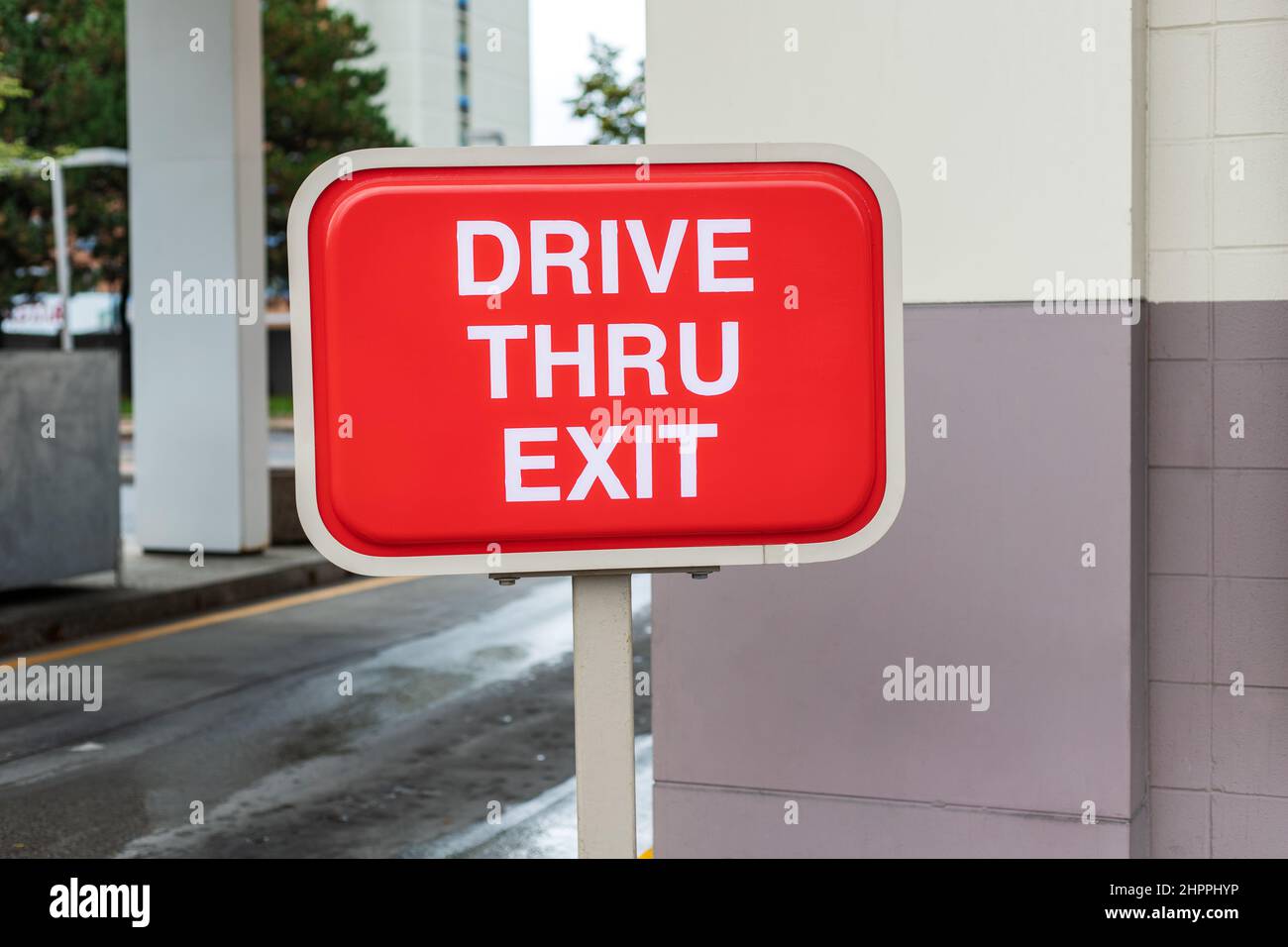 Drive Thru exit red sign near fast food restaurant or cafe Stock Photo