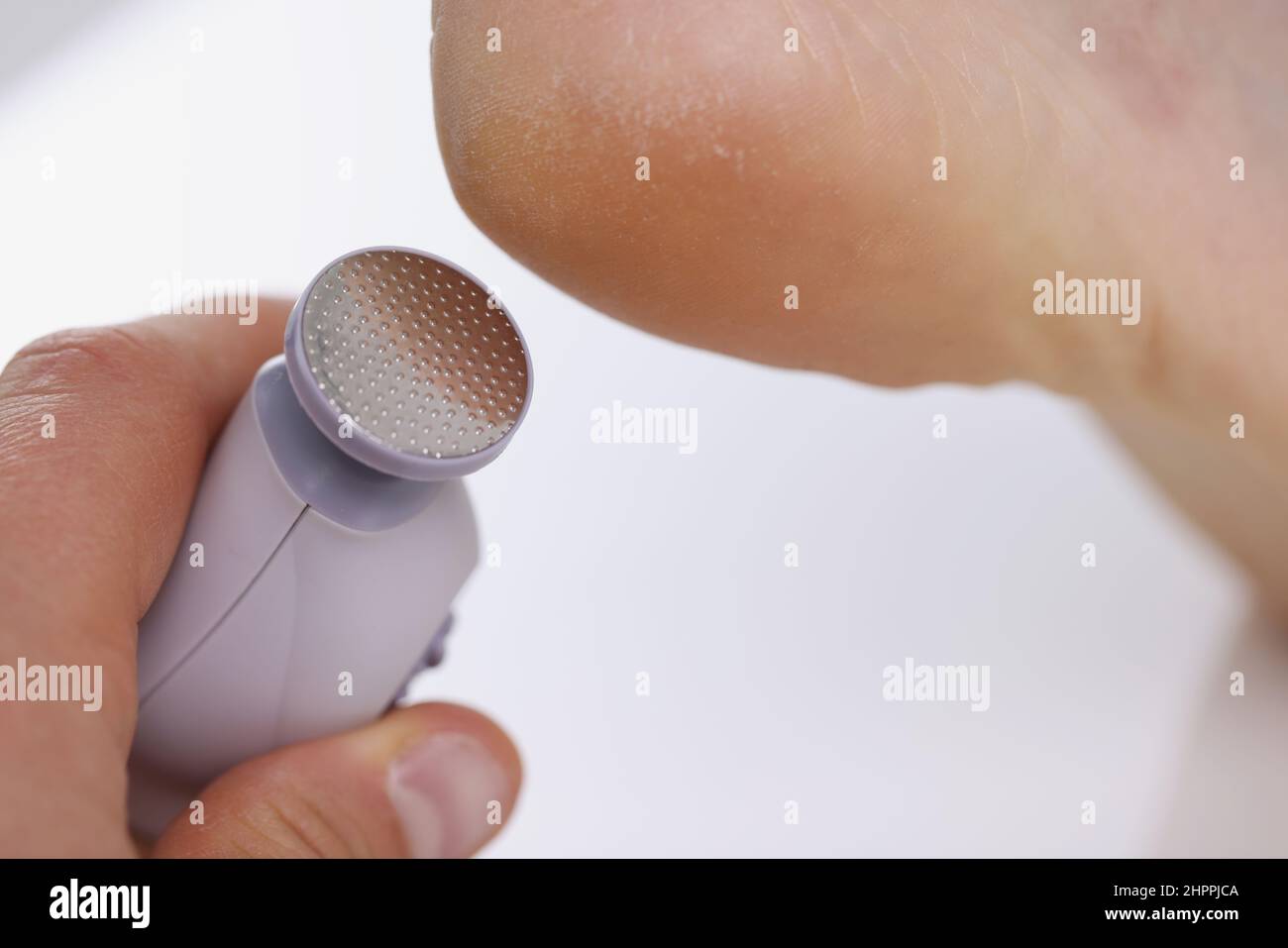 Callus peeling using professional pedicure drill machine. spa foot
