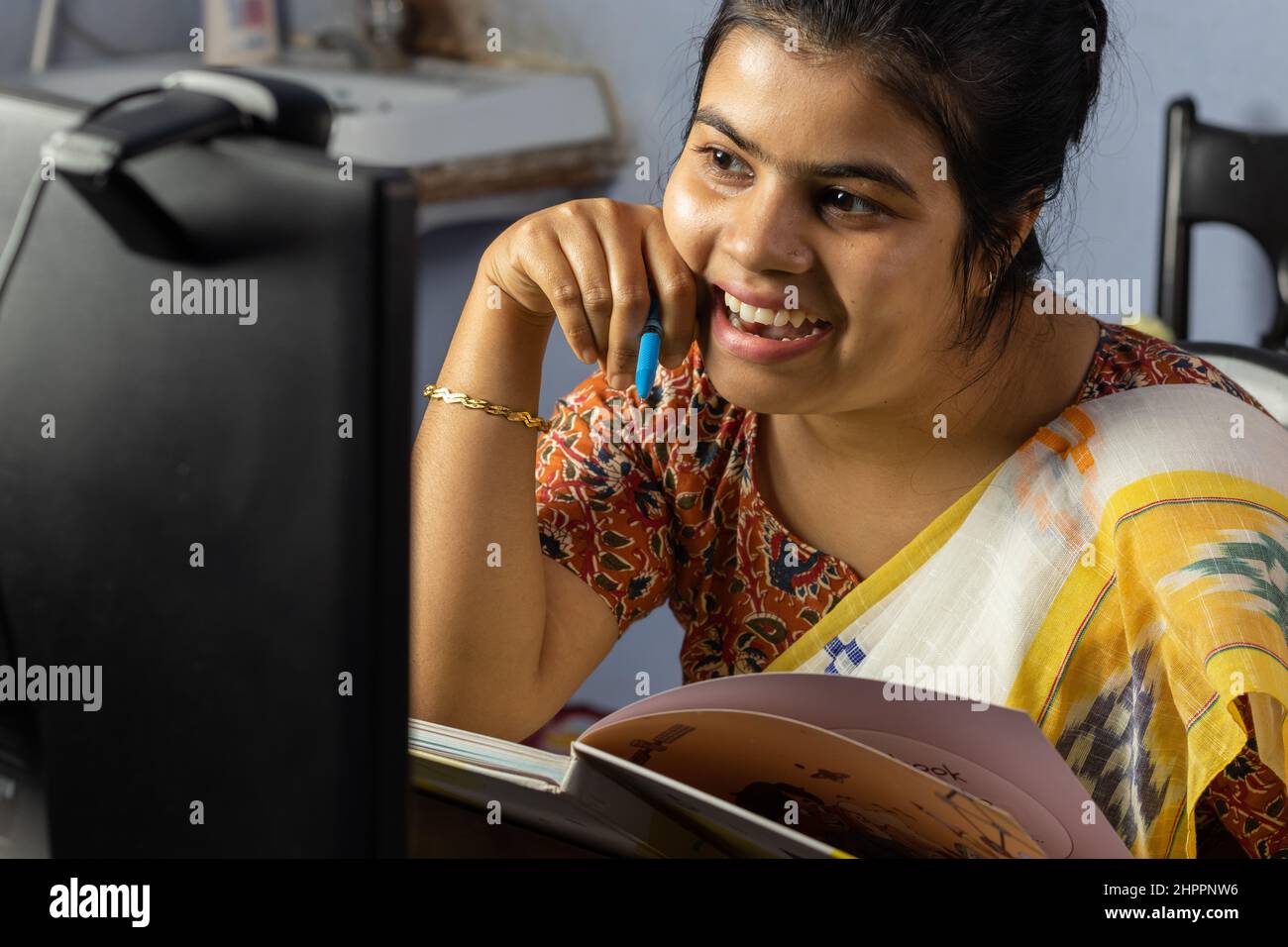 Close up of an Indian woman in saree working on computer at home, work from home concept Stock Photo