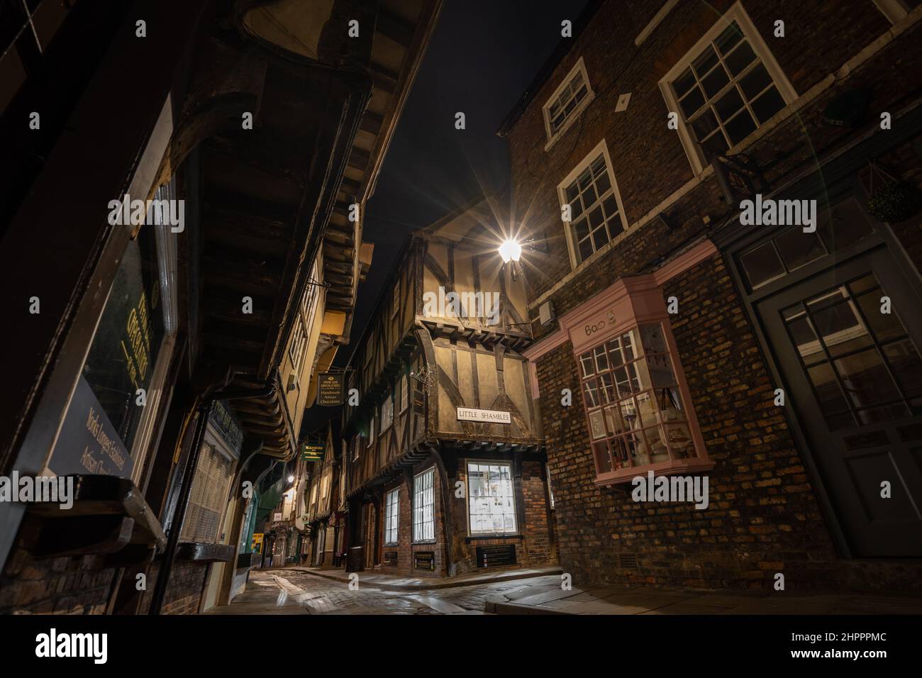The Little Shambles, York Night time photograph of old narrow winding streets and medieval buildings. Butchers row with cobbled lane and shops Stock Photo