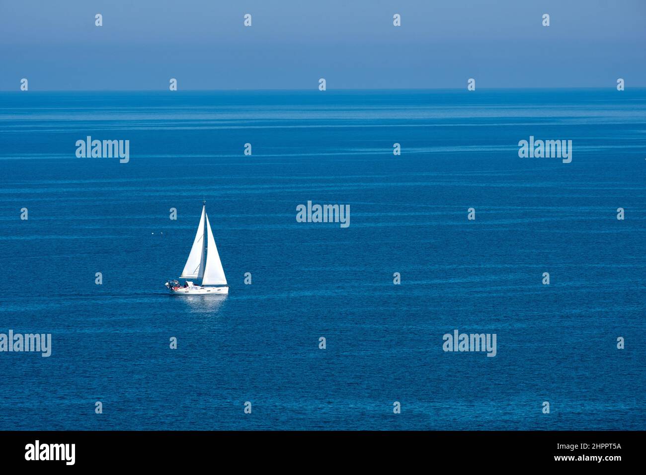 sailing boat in the middle of blue sea quietness harmonious weather Stock Photo