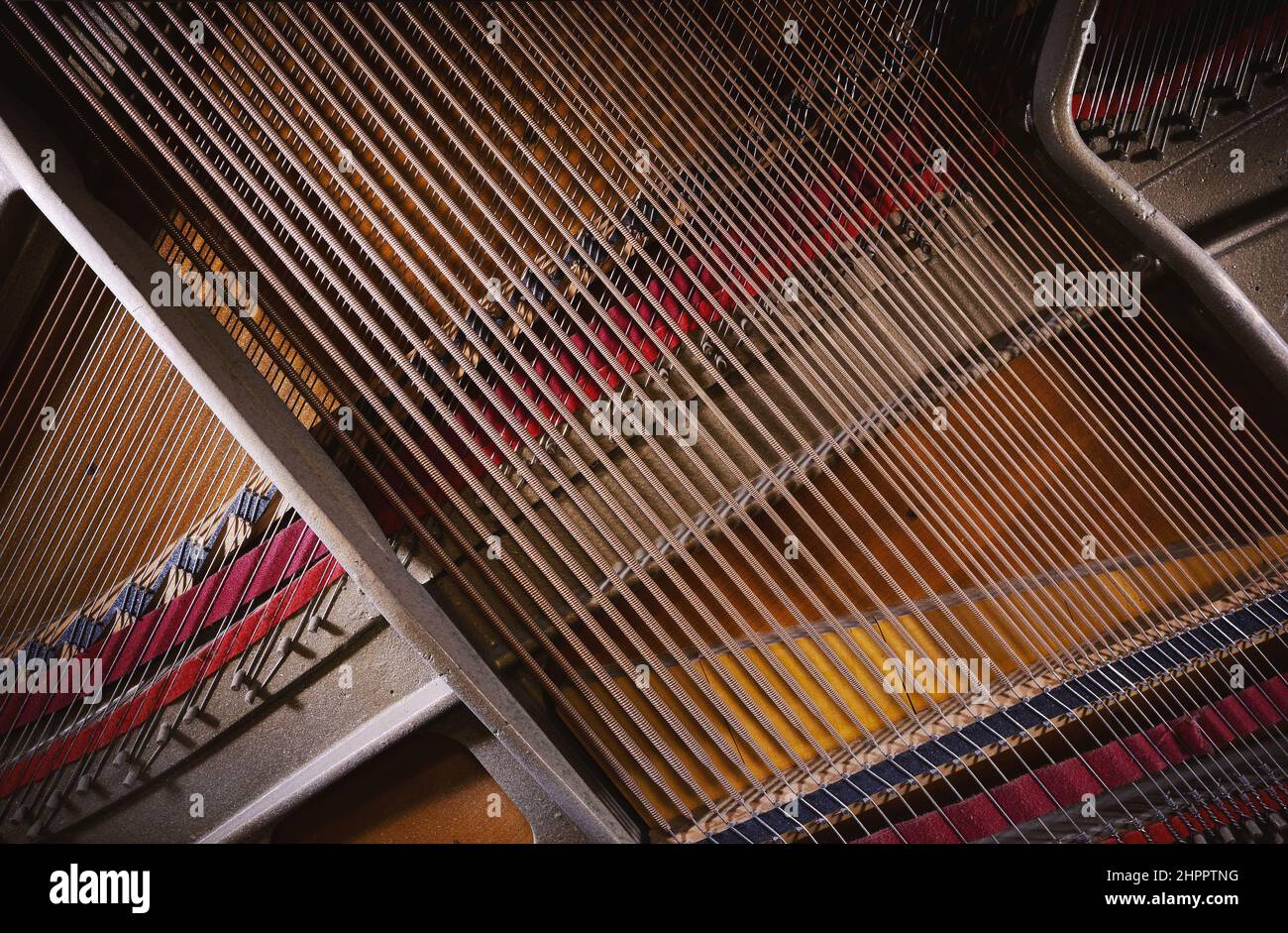 Details of an open upright piano, strings and structure closeup view