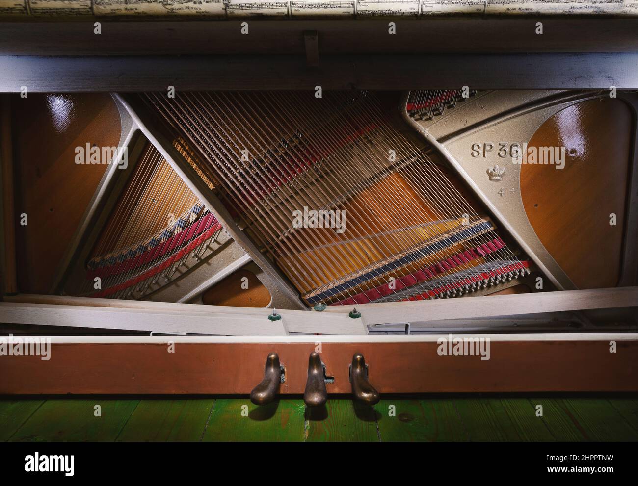 Details of an open upright piano, strings and structure closeup view