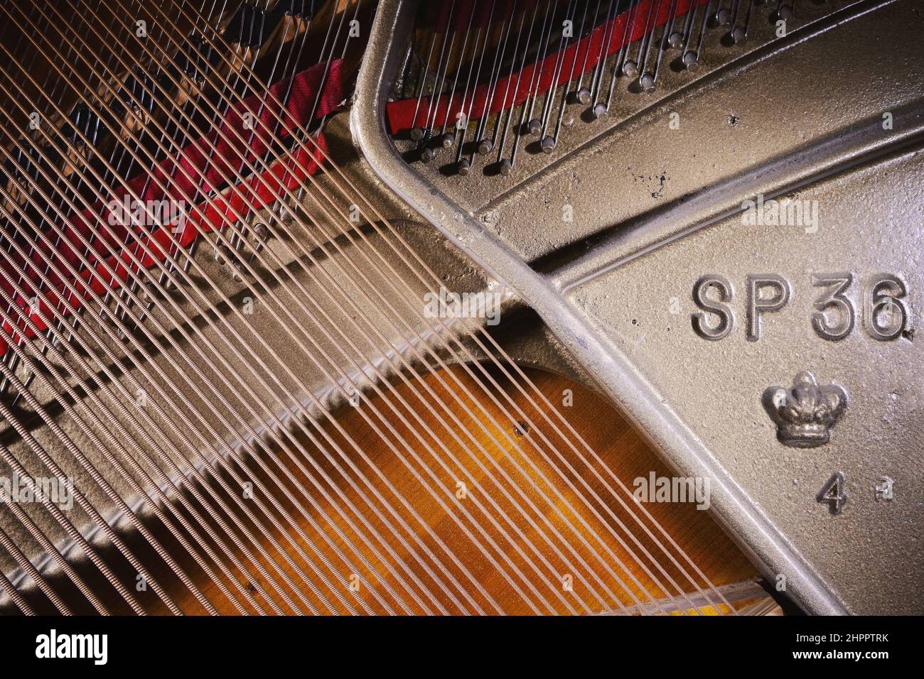Details of an open upright piano, strings and structure closeup view