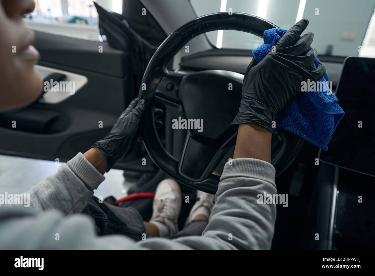 Auto detailing professional dusting car interior surfaces Stock Photo