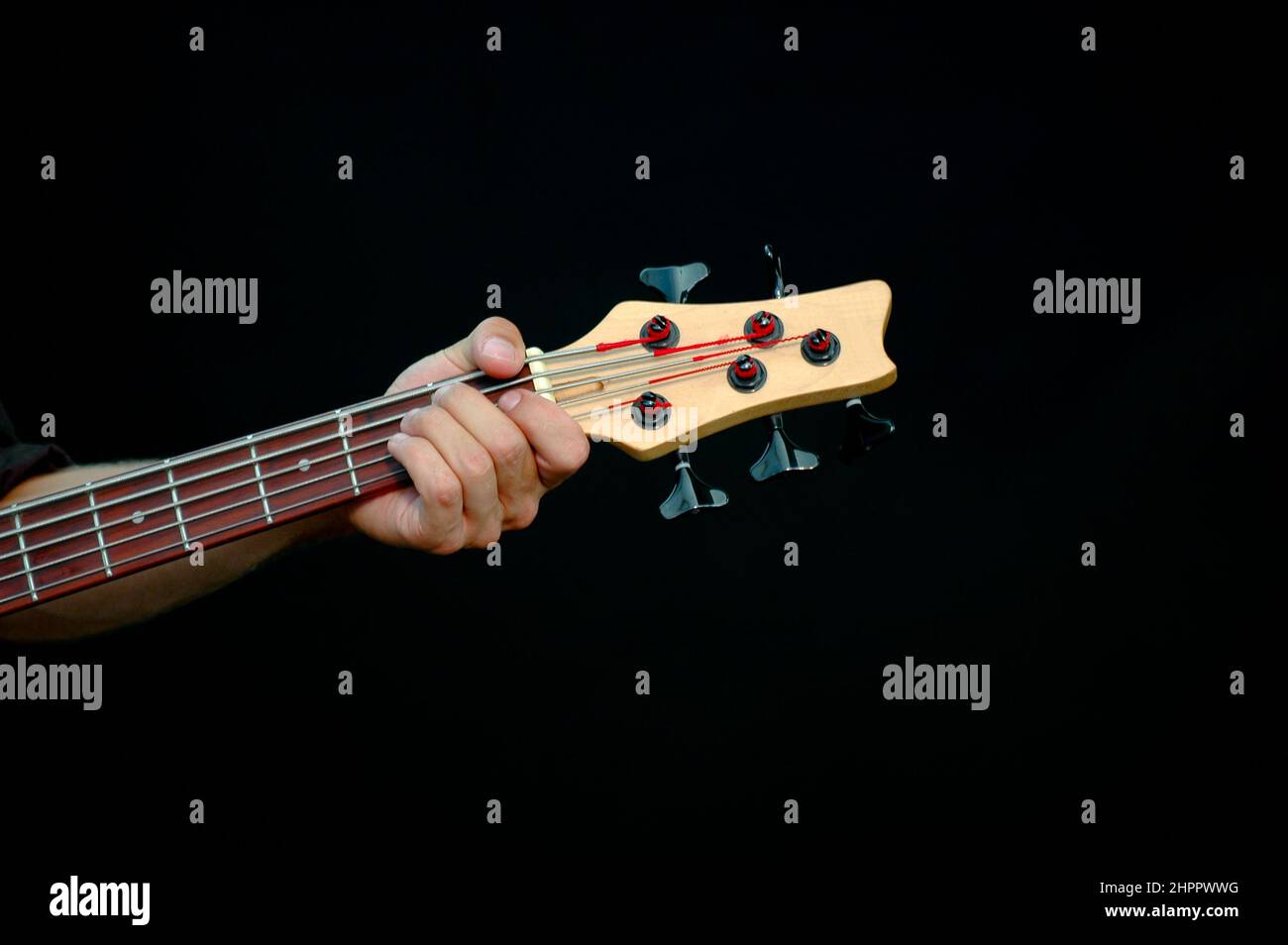 A man is playing his guitar. Taken on a black background. Stock Photo